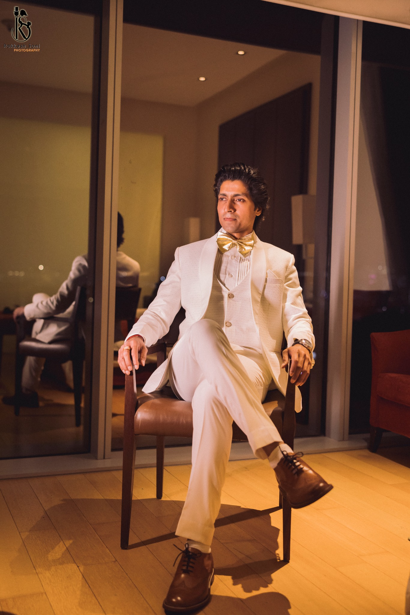 Harsh Kumar Shakti in a white suit, seated in an elegant interior